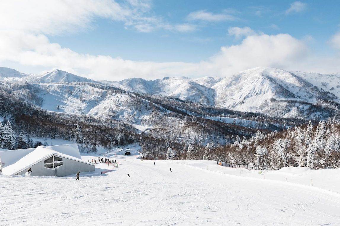 Groomed run and snow-covered mountains at Kiroro Resort, Hokkaido
