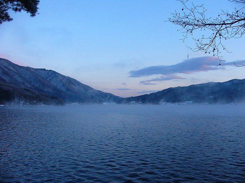 Lake Kizaki, one of Omachi's Nishina Three Lakes, frozen in winter with mountains behind